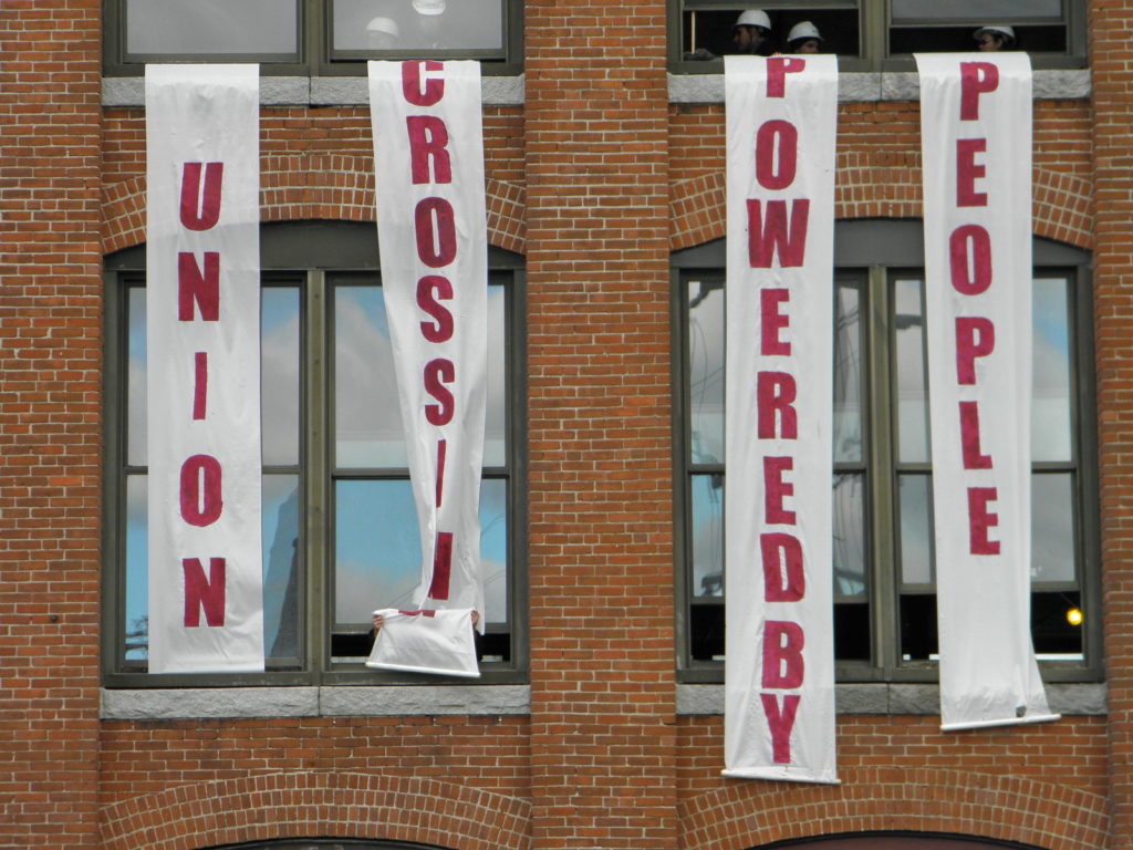 Banners hang from windows reading "Union Crossing Powered By People"