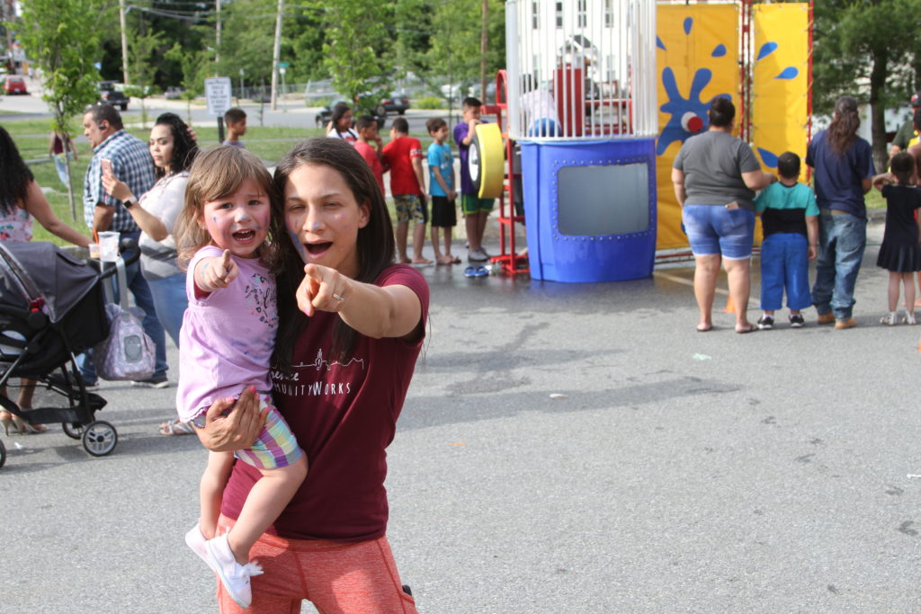 Mother and child point toward camera during LCW's 2018 Block Party