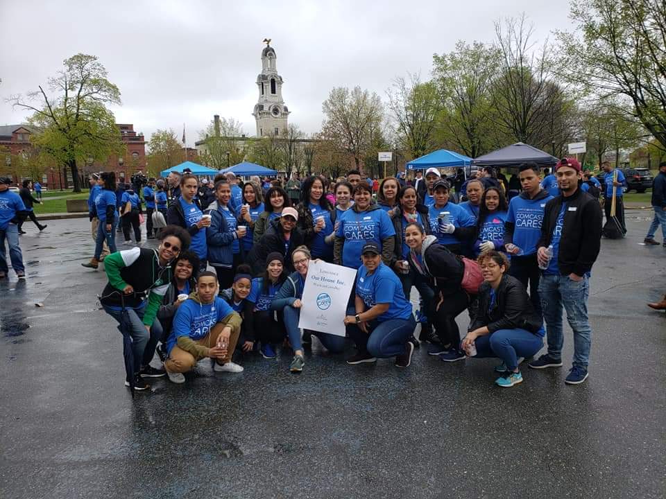 Staff and members pose for a photo during Comcast Cares Day